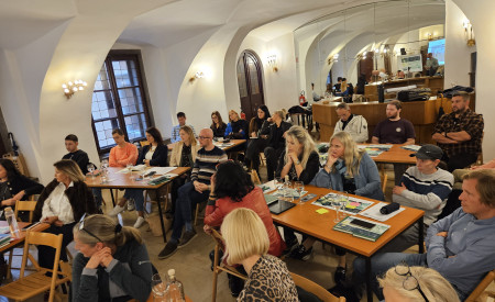 udeleženci posveta sedijo za mizami