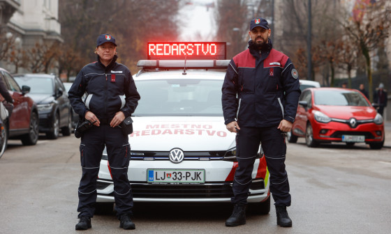 redarja stojita pred službenim vozilom