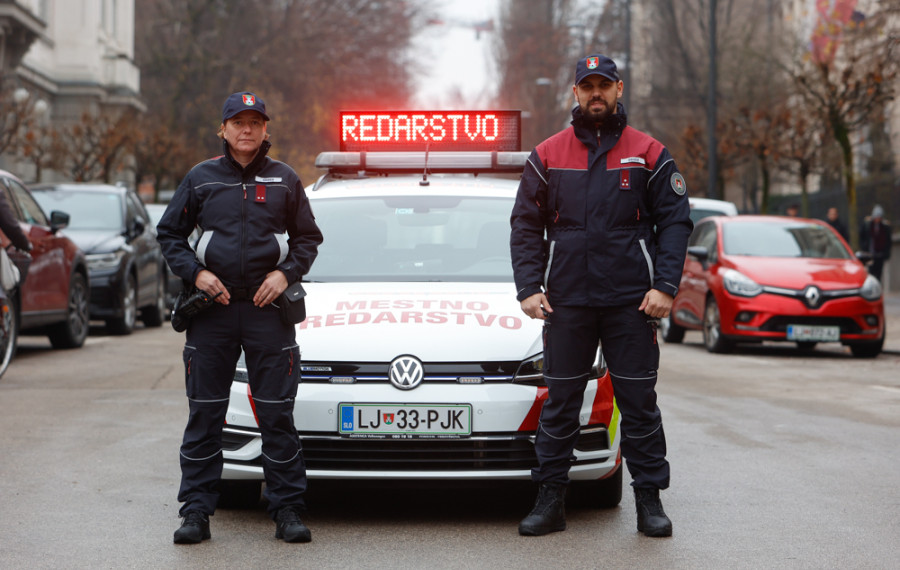 redarja stojita pred službenim vozilom