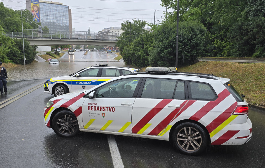 vozila mestnega redarstva ob poplavljenem podvozu