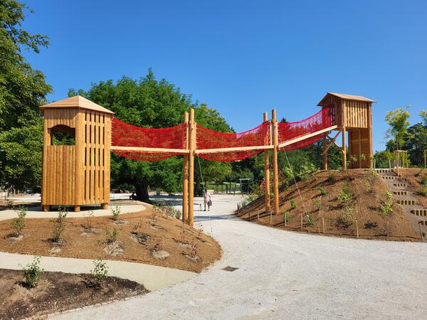 high playground structure of two small houses and a bridge. Photo: archive COL
